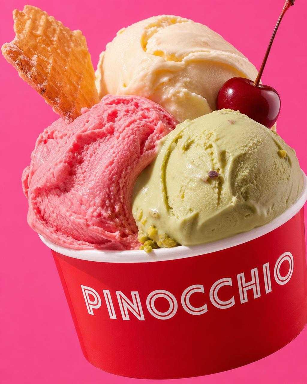 Strawberry, pistachio and vanilla gelato in a red Pinocchio cup